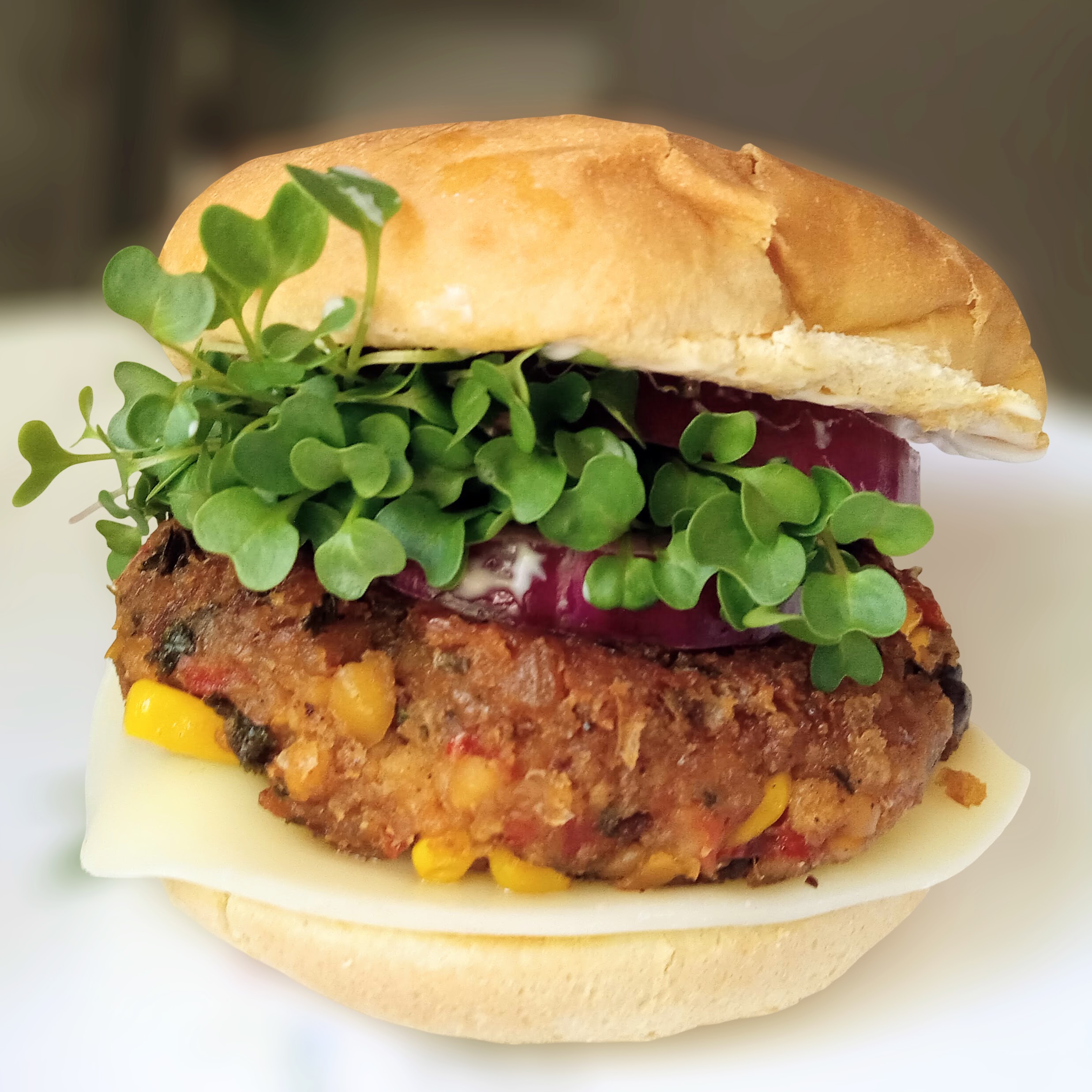 A cooked chipotle black bean burger on a bun.